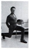 lunge forward with left knee while bracing oneself by holding onto chair back